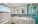 Modern bathroom featuring a vanity with a countertop, LED mirror, and tiled shower at 108 Peckham Sw St, Port Charlotte, FL 33952
