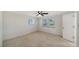 Bright bedroom with tiled floor, ceiling fan, and sun-filled windows at 108 Peckham Sw St, Port Charlotte, FL 33952