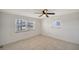 Bedroom with tiled floor, two windows with blinds, and ceiling fan at 108 Peckham Sw St, Port Charlotte, FL 33952