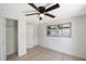 Bright bedroom with tiled floor, closet, and a ceiling fan at 108 Peckham Sw St, Port Charlotte, FL 33952