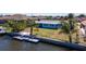 Waterfront home with a private dock and lush, tropical landscaping around property at 108 Peckham Sw St, Port Charlotte, FL 33952