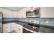Updated kitchen features stainless steel appliances and stylish backsplash at 108 Peckham Sw St, Port Charlotte, FL 33952