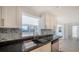 Close up of a kitchen featuring a stainless steel sink and designer backsplash at 108 Peckham Sw St, Port Charlotte, FL 33952
