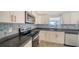 Modern kitchen with stainless steel appliances, granite countertop, and bright cabinets at 108 Peckham Sw St, Port Charlotte, FL 33952