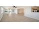 Living room with tile floors, an open floor plan, and access to the kitchen and backyard at 108 Peckham Sw St, Port Charlotte, FL 33952