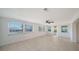 Spacious living area with plenty of natural light, neutral tile, and a ceiling fan at 108 Peckham Sw St, Port Charlotte, FL 33952