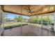 Spacious screened-in patio with ceiling fan, tile flooring, and waterfront views at 108 Peckham Sw St, Port Charlotte, FL 33952