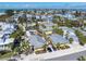 Aerial view of quaint cottages with lush tropical foliage, and a community pool at 110 Oak Ave # A, Anna Maria, FL 34216