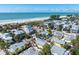 Exceptional aerial view highlighting the community's proximity to the beach and the sparkling ocean at 110 Oak Ave # A, Anna Maria, FL 34216