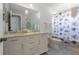 Bright bathroom featuring a double vanity with a white marble countertop and decorative patterned tile floors at 110 Oak Ave # A, Anna Maria, FL 34216