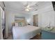 Cozy bedroom featuring a queen bed, beach-themed art, and light wood flooring at 110 Oak Ave # A, Anna Maria, FL 34216