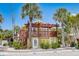 Inviting two-story home with a pergola-covered deck and lush tropical landscaping at 110 Oak Ave # A, Anna Maria, FL 34216