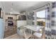 Charming dining nook featuring white cabinets, a butcher block, and a large window at 110 Oak Ave # A, Anna Maria, FL 34216