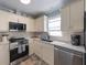 Modern kitchen with granite countertops, stainless steel appliances, and white cabinets at 110 Oak Ave # A, Anna Maria, FL 34216