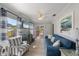 Inviting living room with a blue couch, beach themed decor, and french doors at 110 Oak Ave # A, Anna Maria, FL 34216