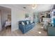 Cozy living room with a comfortable blue sofa, beach-themed decor, and lots of natural light at 110 Oak Ave # A, Anna Maria, FL 34216