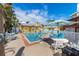 Inviting community pool surrounded by lounge chairs and lush tropical landscaping in a desirable location at 110 Oak Ave # A, Anna Maria, FL 34216