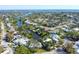 Picturesque aerial view of waterfront homes along a canal, showcasing the neighborhood's unique layout and beautiful landscaping at 115 65Th Street Nw Ct, Bradenton, FL 34209