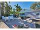 Charming backyard featuring a patio, pool access, seating, and outdoor grill at 115 65Th Street Nw Ct, Bradenton, FL 34209