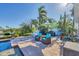 Beautiful backyard patio with outdoor furniture, umbrella and luscious landscaping at 115 65Th Street Nw Ct, Bradenton, FL 34209