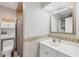 A bathroom with a toilet, shower, sink and storage space at 115 65Th Street Nw Ct, Bradenton, FL 34209