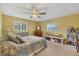 Bright bedroom featuring a ceiling fan, two windows and a shelf for plenty of storage at 115 65Th Street Nw Ct, Bradenton, FL 34209