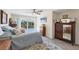 Cozy bedroom with tile floor, a pool view, and vintage dressers at 115 65Th Street Nw Ct, Bradenton, FL 34209