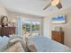 Bedroom with water view, ceiling fan, and sliding glass door at 115 65Th Street Nw Ct, Bradenton, FL 34209