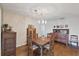 Charming dining room with hardwood floors, vintage furniture, and decorative chandelier at 115 65Th Street Nw Ct, Bradenton, FL 34209