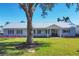 Charming single-story home with a pristine lawn, well-maintained landscaping and metal roof at 115 65Th Street Nw Ct, Bradenton, FL 34209