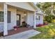 Charming front porch featuring brick accents, potted plants, and a welcoming entrance at 115 65Th Street Nw Ct, Bradenton, FL 34209