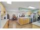 An open kitchen flows into dining area, with wooden cabinets and stainless appliances at 115 65Th Street Nw Ct, Bradenton, FL 34209