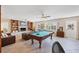 Spacious living area featuring a pool table, fireplace, and comfortable seating at 115 65Th Street Nw Ct, Bradenton, FL 34209