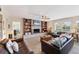 Spacious living room featuring a brick fireplace, built-in bookshelves, and comfortable seating at 115 65Th Street Nw Ct, Bradenton, FL 34209