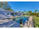 An inviting in-ground pool is surrounded by a brick patio and lush, tropical landscaping at 115 65Th Street Nw Ct, Bradenton, FL 34209