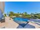 Refreshing backyard pool with brick patio, lush landscaping, and waterfront views at 115 65Th Street Nw Ct, Bradenton, FL 34209