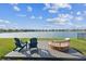 Backyard deck with lounge chairs offers serene waterfront view at 11659 Little River Way, Parrish, FL 34219