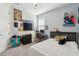 Bedroom with a large window, workspace, a tv, and neutral wall color at 11659 Little River Way, Parrish, FL 34219
