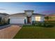 Charming single-story home featuring a well-manicured lawn and an inviting brick driveway at 11659 Little River Way, Parrish, FL 34219
