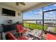 Relaxing screened patio area with comfortable seating overlooking the lake at 11659 Little River Way, Parrish, FL 34219