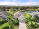 Aerial view of the property showcasing a well-maintained lawn, pond view, and beautiful landscaping at 11742 Forest Park Cir, Bradenton, FL 34211