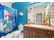 Whimsical bathroom with a playful nautical theme, custom shark decor, and plenty of counter space at 11742 Forest Park Cir, Bradenton, FL 34211