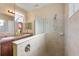 Bathroom featuring a glass-enclosed shower, double sinks, and neutral tile at 11742 Forest Park Cir, Bradenton, FL 34211