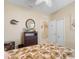 Relaxing bedroom with a leafy patterned comforter, decorative mirror and dresser, and closet at 11742 Forest Park Cir, Bradenton, FL 34211