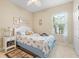 Bedroom with coastal decor, a ceiling fan, and natural light from the window at 11742 Forest Park Cir, Bradenton, FL 34211