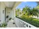 Charming front porch with patterned tile, white railing, and lush landscaping, welcoming curb appeal at 11742 Forest Park Cir, Bradenton, FL 34211