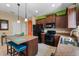 Well-lit kitchen with a center island, dark wood cabinets, stainless steel appliances, and tile flooring at 11742 Forest Park Cir, Bradenton, FL 34211