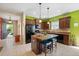Bright kitchen with an island, dark wood cabinets, and stainless steel appliances seamlessly integrated into the design at 11742 Forest Park Cir, Bradenton, FL 34211