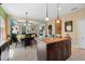 Open kitchen with a center island, tile flooring, seamlessly connected to the dining area and living room at 11742 Forest Park Cir, Bradenton, FL 34211