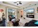 Cozy living room featuring beach-themed decor, a sliding glass door to the pool, and modern furniture at 11742 Forest Park Cir, Bradenton, FL 34211